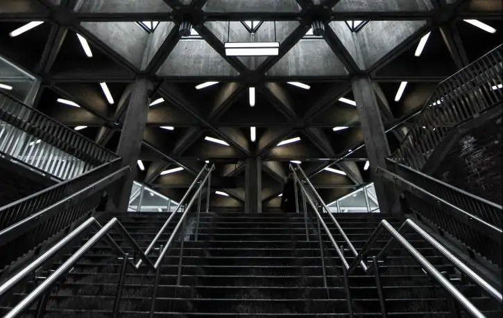 architecture-triangle-housetop Tiled glass construction in pyramid shape lit with green-violet light