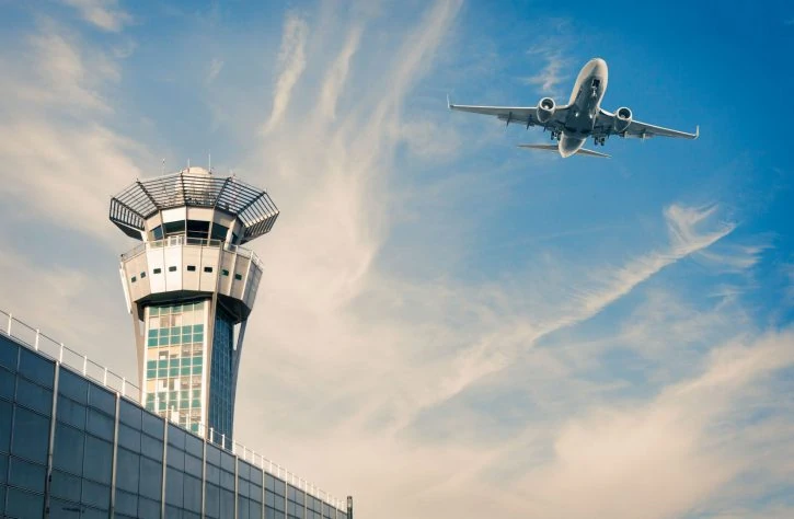 enav-orts-success-story-2048x1340-srgb-web Airplane over airport and terminal with blue skies and soft clouds